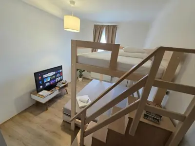 a bedroom with a bed and a desk with a lamp at Apartment Paulie 3min to Metro Near O2 Arena and City Centre in Prague