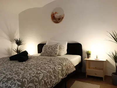 a bedroom with a bed and a clock on the wall at Za hrází Poděbrady in Poděbrady