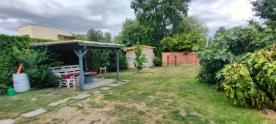a backyard with a bench and a shed at Za hrází Poděbrady in Poděbrady