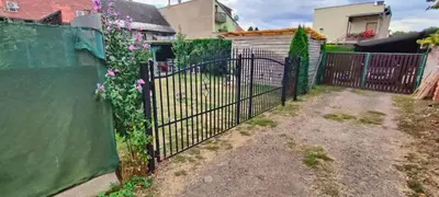 a fence with a gate with flowers on it at Za hrází Poděbrady in Poděbrady