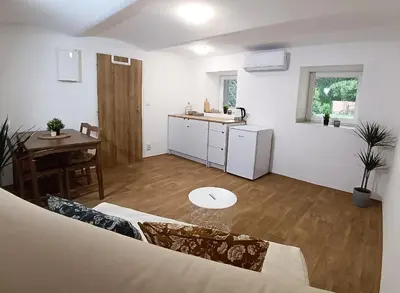 a living room with a table and a kitchen at Za hrází Poděbrady in Poděbrady