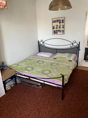 a small bedroom with a bed in a room at HANDY FLAT WITH SAUNA and TUBE-UBahn in Prague