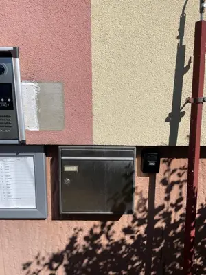 a wall with a pay phone next to a building at HANDY FLAT WITH SAUNA and TUBE-UBahn in Prague