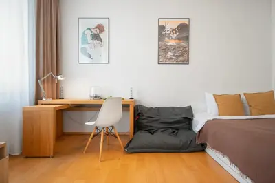 a bedroom with a bed and a desk with a laptop at Heart of the City Studio in Prague