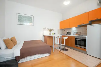 a flat screen tv sitting on a stand in a living room at Heart of the City Studio in Prague