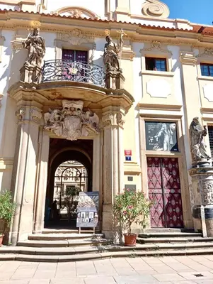 a building with an arch with a balcony on it at Prague centrum apartment Hradčany in Prague