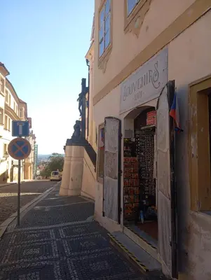 a store on the side of a building on a street at Prague centrum apartment Hradčany in Prague