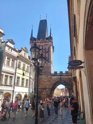 a crowd of people walking through an archway at Prague centrum apartment Hradčany in Prague