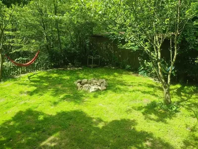 a garden with a stone sculpture in the grass at Romantic cottage Slapy - Renovated