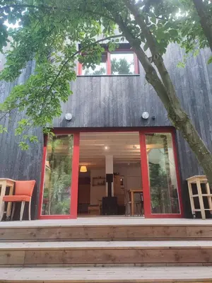 a house with red trim and a tree at Romantic cottage Slapy - Renovated