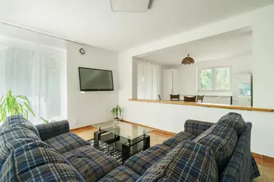 a living room with two couches and a glass table at Strom času