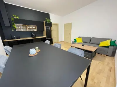 a living room with a table and a couch at Living in Prague 1 in Prague