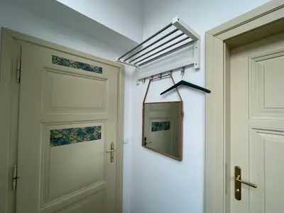 a hallway with a door and a mirror on the wall at Living in Prague 1 in Prague
