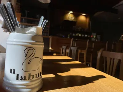a jar of utensils sitting on top of a table at Restaurace a Penzion U Labutě in Prague