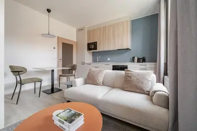 a living room with a white couch and a table at Blueground Nusle city view nr Vysehrad PRG-69 in Prague