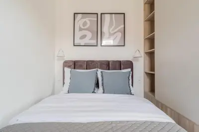 a bedroom with a large bed with blue pillows at Blueground Nusle city view nr Vysehrad PRG-69 in Prague