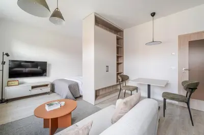a living room with a couch and a table at Blueground Nusle city view nr Vysehrad PRG-69 in Prague