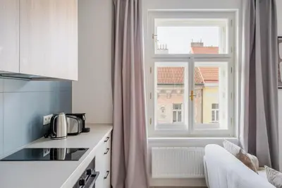 a kitchen with a window and a white counter top at Blueground Nusle city view nr Vysehrad PRG-69 in Prague