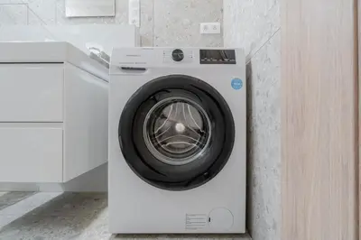 a white washing machine in a white kitchen at Blueground Nusle city view nr Vysehrad PRG-69 in Prague