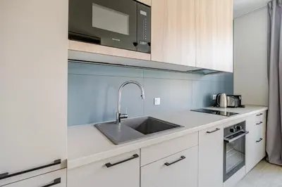 a kitchen with a sink and a microwave at Blueground Nusle city view nr Vysehrad PRG-69 in Prague