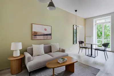 a living room with a couch and a table at Blueground Nusle balcony nr Vysehrad PRG-72 in Prague