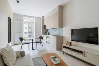a living room with a large television and a table at Blueground Nusle balcony nr Vysehrad PRG-72 in Prague