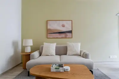 a living room with a couch and a table at Blueground Nusle balcony nr Vysehrad PRG-72 in Prague