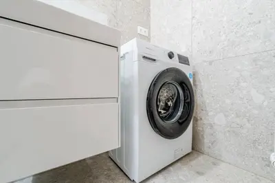 a white washer and dryer in a room at Blueground Nusle balcony nr Vysehrad PRG-64 in Prague