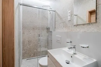 a bathroom with a shower and a sink and a toilet at Blueground Nusle balcony nr Vysehrad PRG-64 in Prague