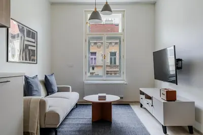 a living room with a couch and a table at Blueground Nusle balcony nr Vysehrad PRG-64 in Prague