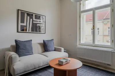a living room with a couch and a table at Blueground Nusle balcony nr Vysehrad PRG-64 in Prague