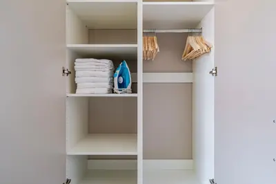 a closet with white shelves and towels at Blueground Nusle view nr Vyšehrad PRG-70 in Prague