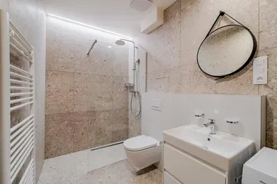 a bathroom with a toilet and a sink and a mirror at Blueground Nusle view nr Vyšehrad PRG-70 in Prague