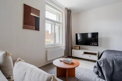 a living room with a couch and a tv and a table at Blueground Nusle view nr Vyšehrad PRG-70 in Prague