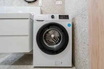 a white washing machine in a kitchen next to a counter at Blueground Nusle view nr Vyšehrad PRG-70 in Prague