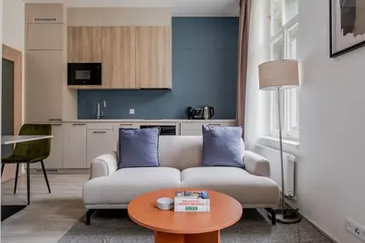 a living room with a couch and a table at Blueground Nusle city view nr Vysehrad PRG-62 in Prague