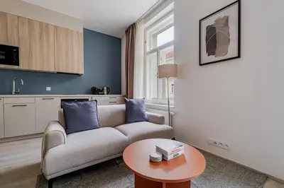 a living room with a couch and a table at Blueground Nusle city view nr Vysehrad PRG-62 in Prague