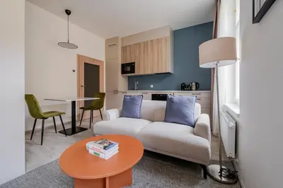a living room with a couch and a table at Blueground Nusle city view nr Vysehrad PRG-62 in Prague