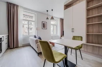 a kitchen and dining room with a table and chairs at Blueground Nusle city view nr Vysehrad PRG-62 in Prague