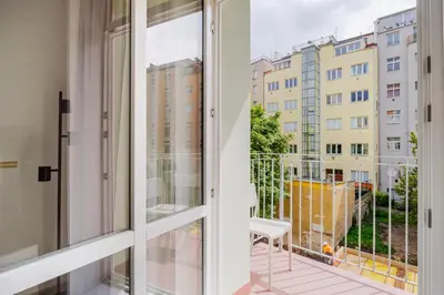 a balcony with a view of a building at Blueground Nusle balcony nr Vysehrad PRG-67 in Prague