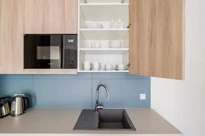 a kitchen with a sink and a microwave at Blueground Nusle balcony nr Vysehrad PRG-67 in Prague