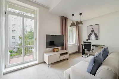 a living room with a couch and a flat screen tv at Blueground Nusle balcony nr Vysehrad PRG-67 in Prague