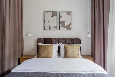 a bedroom with a large bed with white sheets and pillows at Blueground Nusle balcony nr Vysehrad PRG-67 in Prague