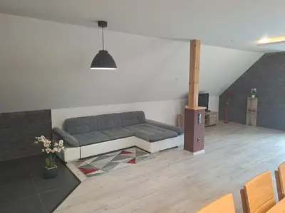 a living room with a couch and a table at H apartment in Jankov
