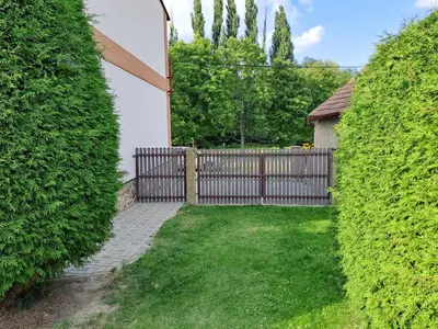 a wooden fence with a gate in a yard at H apartment in Jankov