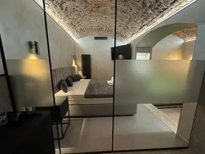 a bedroom with a bed and a mirror at SPA SPA Karlín in Prague