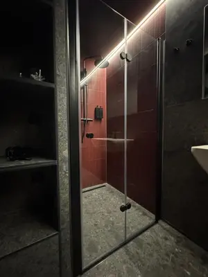 a bathroom with a shower with a glass door at SPA SPA Karlín in Prague