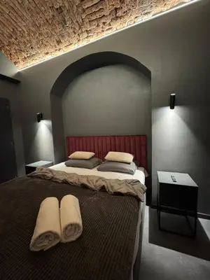 a bedroom with a large bed with two towels on it at SPA SPA Karlín in Prague