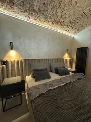 a bedroom with a bed with two pillows on it at SPA SPA Karlín in Prague