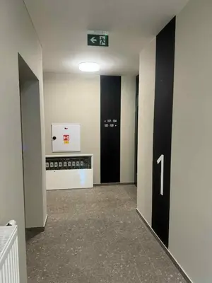 a hallway with two elevators in a building at New Apartment Prague 5 in Prague